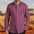 Red and white plaid shirt worn by a person on a white background