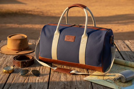 Pilbara Overnight Bag in navy blue with leather trims on rustic timber surface