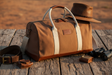 Pilbara Overnight Bag in brown with leather trims on rustic timber surface