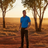 Man wearing Ritemate Pilbara Classic Polo in Australian outback landscape