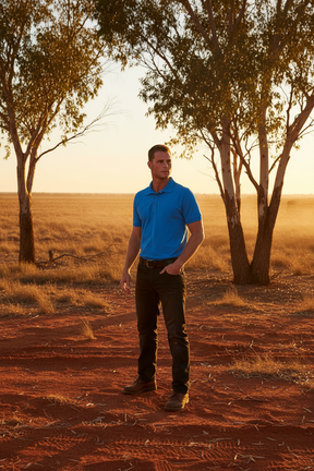 Man wearing Ritemate Pilbara Classic Polo in Australian outback landscape