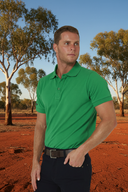 Man wearing Ritemate Pilbara Classic Polo in Emerald with Australian outback background
